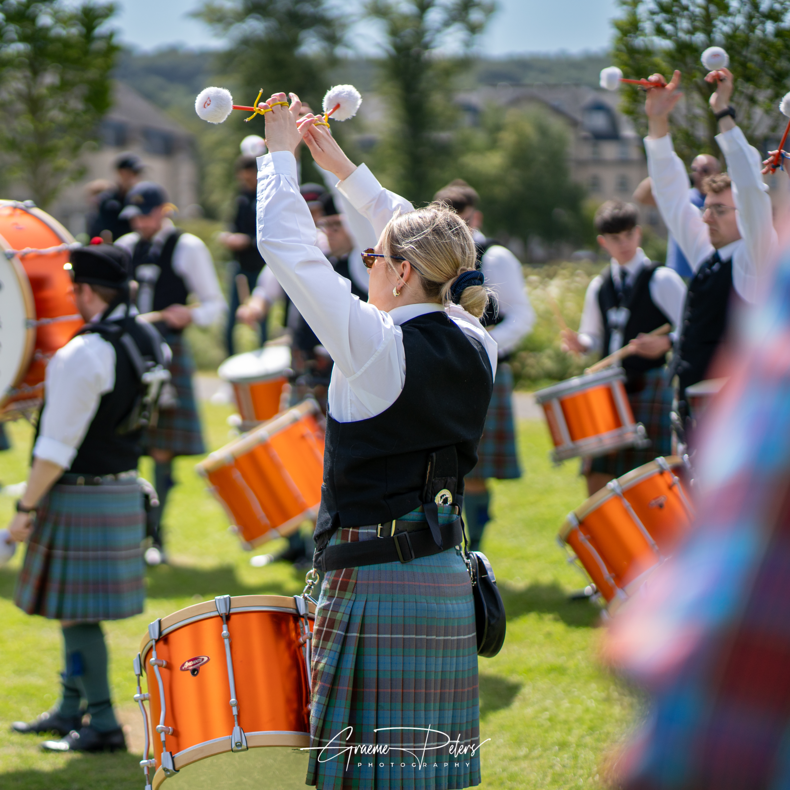 A tenor drummer from Peoples Ford Boghall and Bathgate Pipe Band mid flourish.